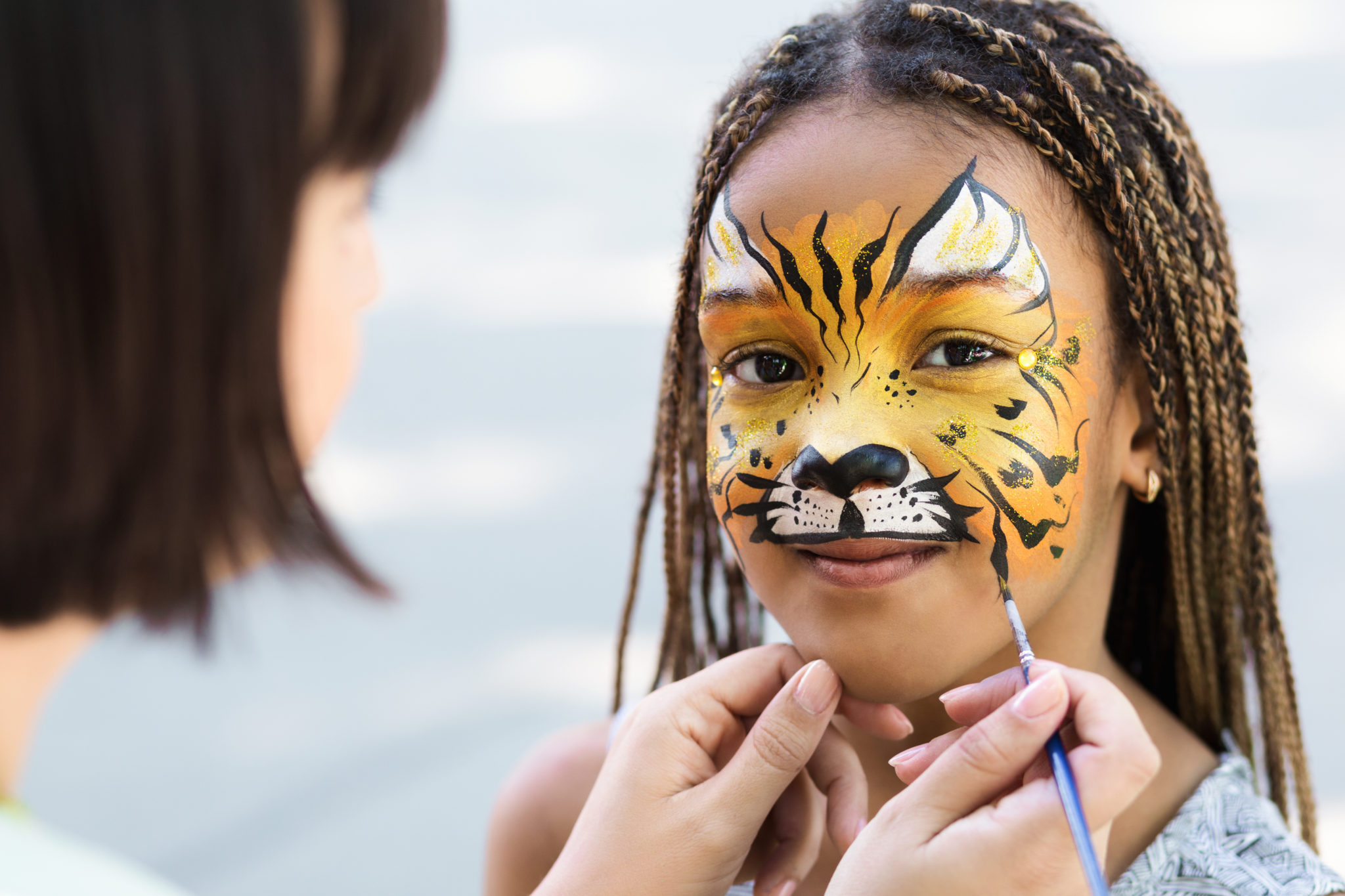 Cute,Little,Tiger.,African-american,Girl,Getting,Face,Painting,Outdoors,,Having